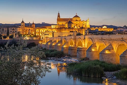 Sur District, Cordoba, Andalusia, Spain. Evening view, San Rafael Bridge over Guadalquivir River. European Print